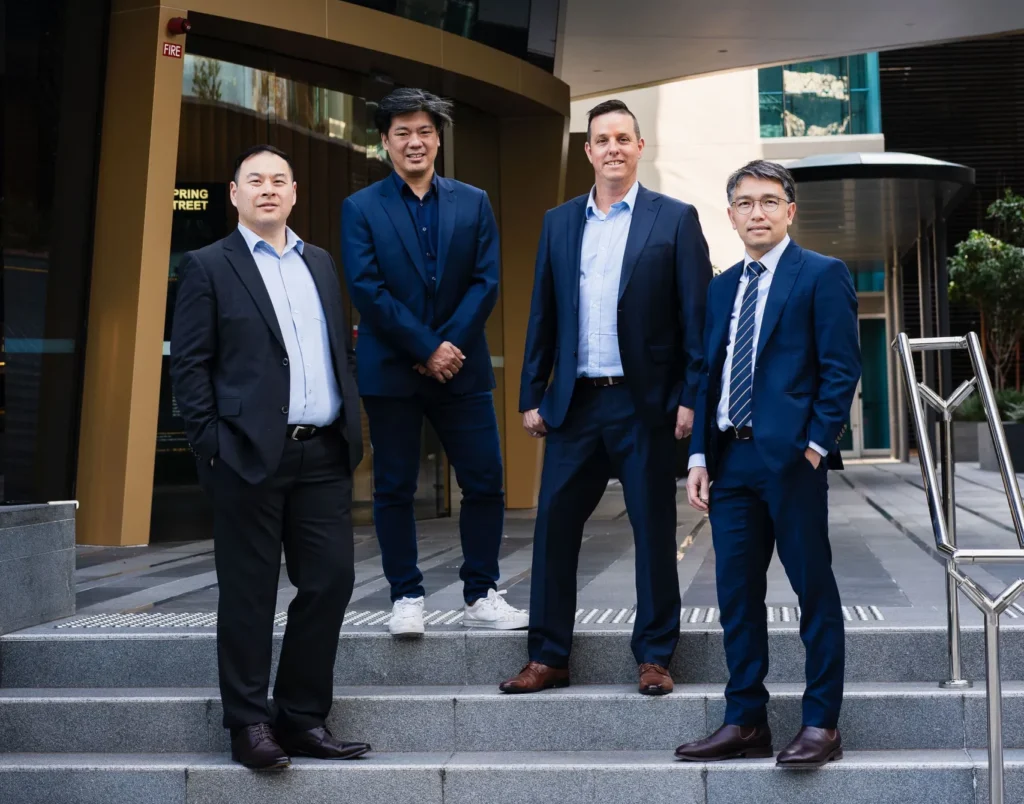 Managing Directors standing on a modern corporate outside,after a high-level strategic discussion.